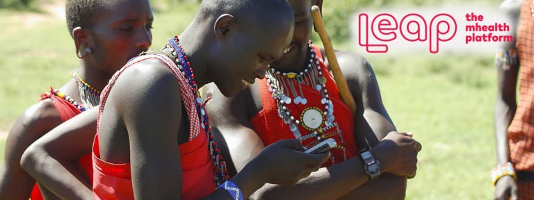 Masai people looking at a mobile phone
